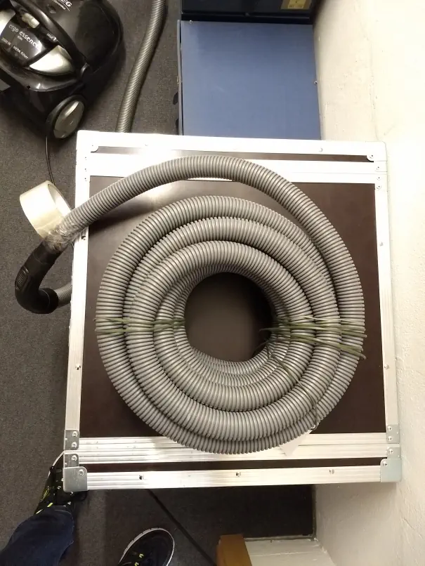 A vaccuum connected to a long hose